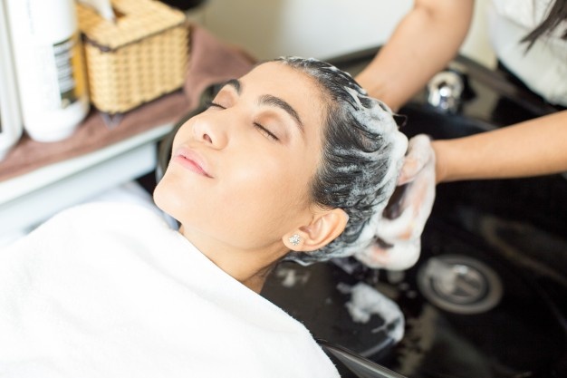 relaxed young woman enjoying hair washing salon 1262 3612